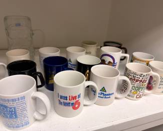 Assorted advertising coffee mugs and glass stein