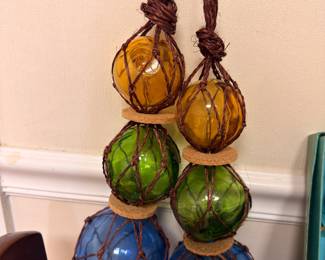 Colored glass fishing floats in rope netting