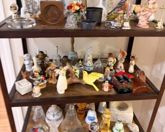 Etagere of collectible bells and porcelain figurines