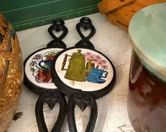 Pair of cast iron tile trivets, coffee pot motif