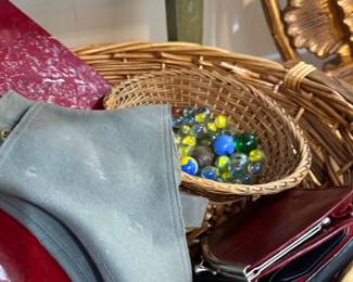 Basket of vintage marbles and leather wallets