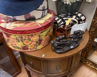 Demilune console table with vintage hats and hat boxes
