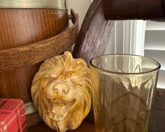 Carved lion head corbel and amber glass tumbler