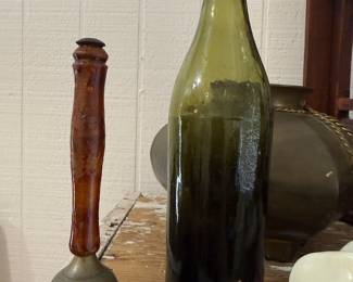 Antique olive green glass beer bottle and stone bell