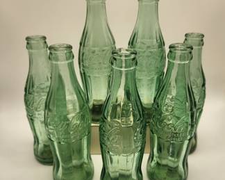 These Coca Cola bottles dated from '52- '64 are from bottling companies in Florence, Corinth, Tupelo, Jackson, Baton Rouge, Russelville and Houston, Ms.