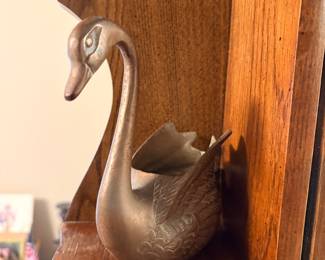 vintage brass swan planter featuring a graceful curved neck and detailed embossed wing feather texturing