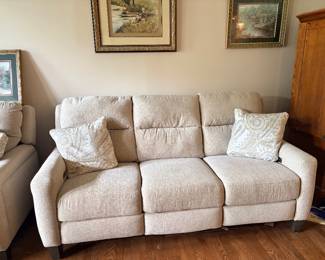 Havertys Ava Fabric Power Reclining Loveseat upholstered in a textured neutral oatmeal fabric with integrated metal power control buttons and a USB charging port