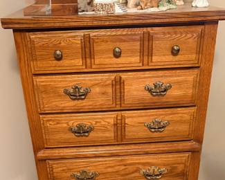 vintage Lenoir House solid oak 5-drawer chest manufactured by Broyhill Furniture Industries, featuring distinct brass-finish hardware and multi-tier drawer facings
