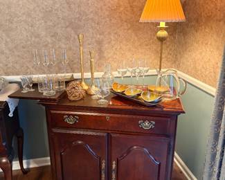 traditional cherry wood flip-top buffet server and bar cabinet features a rich mahogany finish with classic brass hardware and an expandable slide-out top surface
