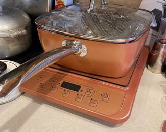 Copper Chef portable induction cooktop paired with a square copper-colored casserole pan and glass lid
