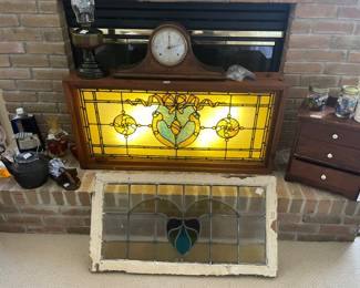 antique leaded and jeweled stained glass transom window featuring a central blue cartouche design with amber roundels and textured cathedral glass in a wooden frame