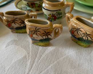 Vintage miniature Japanese lusterware tea set featuring hand-painted tropical landscape and palm tree motifs