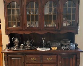 Solid pine china cabinet by broyhill furniture company hutch has 4 wood and glass doors with brass panes. Base has 2 doors for hidden storage and 5 drawers for extra storage in a dark chestnut brown stain