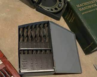 A gray metal Huot fractional drill bit index and storage case containing a set of high-speed steel jobber-length twist drill bits sized from 1/16" to 1/2" in 1/64" increments.