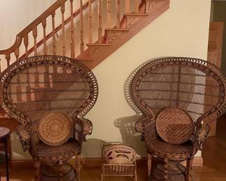 vintage mid-20th-century wicker and rattan Emmanuelle peacock chair features a dramatic flared fan back and an intricate hourglass pedestal base