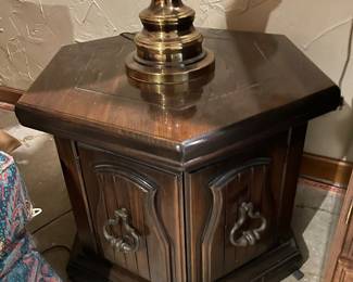 vintage Mediterranean-style hexagonal wooden end table featuring a rich dark wood finish and ornate brass-toned ring pull hardware.