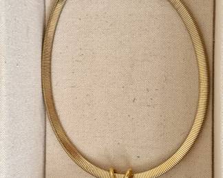 Gold tone necklace. Pendant can be switched from a black stone to a white stone