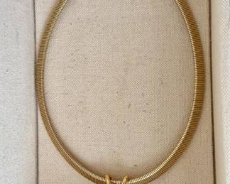 Gold tone necklace. Pendant can be switched from a black stone to a white stone
