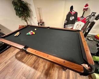 Brunswick pool table with black felt top