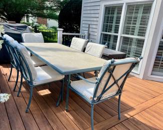 Outdoor patio table with six chairs and cushions
