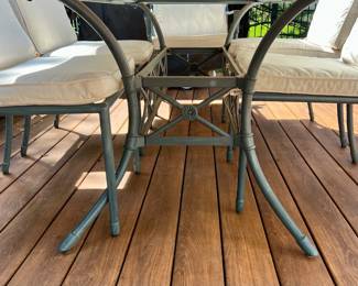 Outdoor patio table with six chairs and cushions