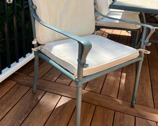 Outdoor patio table with six chairs and cushions