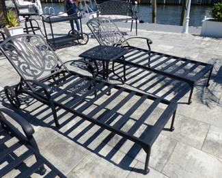 4 outdoor cast aluminum chaise lounges (no cushions) and 2 side tables