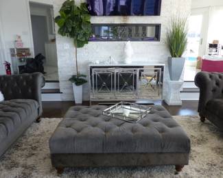 Stunning gray velvet tufted back sofa, loveseats, tufted ottoman & area rug, mirrored sideboard
