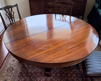 B41 - $950. Round Wooden Dining Table with 8 Chairs. Table is 5' round x 29.5" tall. Floor to bottom of table lip is 25.5".  Table has 3 leaves. 2 - 18" leaves. 1 - 13" leaf. Includes table pads for all. Overall very good vintage condition, a few surface marks not deep gouges. Chairs are all sturdy with varying wear on cushions and wood.  