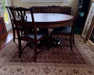B41 - $950. Round Wooden Dining Table with 8 Chairs. Table is 5' round x 29.5" tall. Floor to bottom of table lip is 25.5".  Table has 3 leaves. 2 - 18" leaves. 1 - 13" leaf. Includes table pads for all. Overall very good vintage condition, a few surface marks not deep gouges. Chairs are all sturdy with varying wear on cushions and wood.  