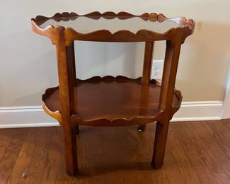 B22 - $145. Oval Two Tiered Wooden Side Table. Top level has glass piece for protecting the wood. Measures 19" x 27.75" x 28.25" tall. 