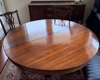 B41 - $950. Round Wooden Dining Table with 8 Chairs. Table is 5' round x 29.5" tall. Floor to bottom of table lip is 25.5".  Table has 3 leaves. 2 - 18" leaves. 1 - 13" leaf. Includes table pads for all. Overall very good vintage condition, a few surface marks not deep gouges. Chairs are all sturdy with varying wear on cushions and wood.  