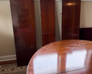 B41 - $950. Round Wooden Dining Table with 8 Chairs. Table is 5' round x 29.5" tall. Floor to bottom of table lip is 25.5".  Table has 3 leaves. 2 - 18" leaves. 1 - 13" leaf. Includes table pads for all. Overall very good vintage condition, a few surface marks not deep gouges. Chairs are all sturdy with varying wear on cushions and wood.  