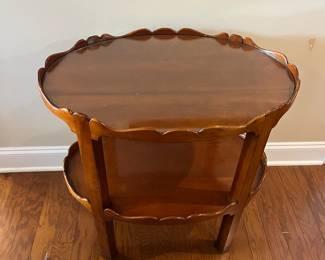 B22 - $145. Oval Two Tiered Wooden Side Table. Top level has glass piece for protecting the wood. Measures 19" x 27.75" x 28.25" tall. 
