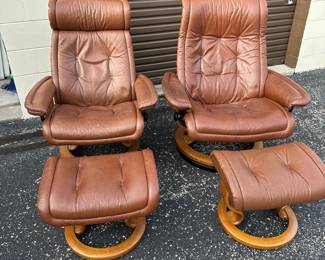 Pair of Ekornes leather chairs with ottomans