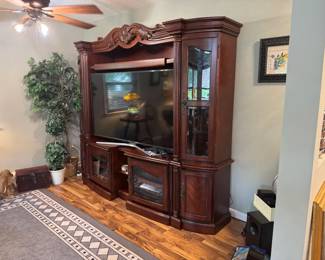 Really unique adjustable-width wall entertainment center "X-Pandable" slides to fit the TV, currently housing a 65" Samsung TV. 