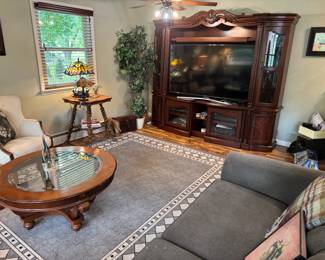 Really unique adjustable-width wall entertainment center "X-Pandable" slides to fit the TV, currently housing a 65" Samsung TV. Rug is 7'10"x10'