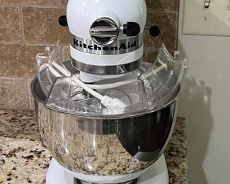 Kitchen Aid Mixer with several attachments and stand cover. $75