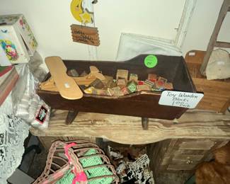 DOLL CRADLE FULL OF WOODEN BLOCKS