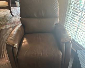 Brown leather recliner. Arms a little worn but still in great condition.