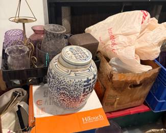 Blue and white ginger jar, decorative items, and collectibles near fireplace mantel
