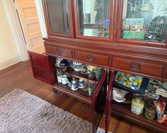 Antique wood china cabinet with glass display doors, collectibles, and dishware