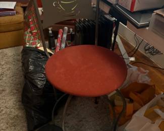 Red upholstered stool, storage containers, and assorted household items