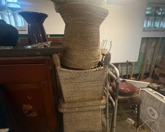 Stacked woven wicker baskets in assorted sizes with household items