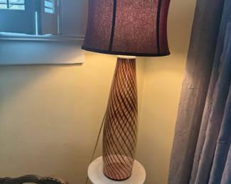 Decorative table lamp with sculpted base and fabric shade