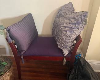 Upholstered accent chair with wood frame and decorative throw pillows