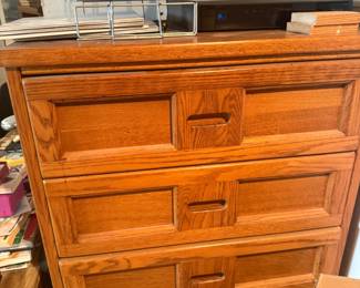 Solid wood chest of drawers with carved panel details and brass hardware