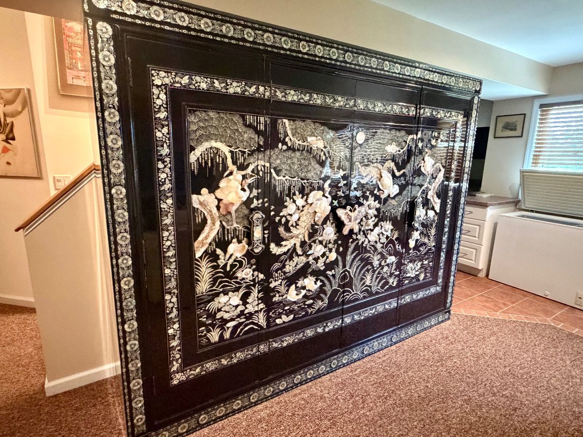 large vintage Korean black lacquer wardrobe cabinet featuring intricate mother-of-pearl and abalone inlay, known as Najeonchilgi