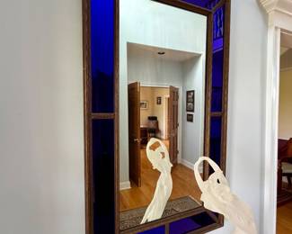 wall mirror featuring brilliant cobalt blue glass panels framed 