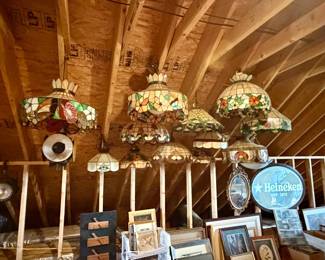 collection of vintage Tiffany-style stained glass hanging lamps and dome shades